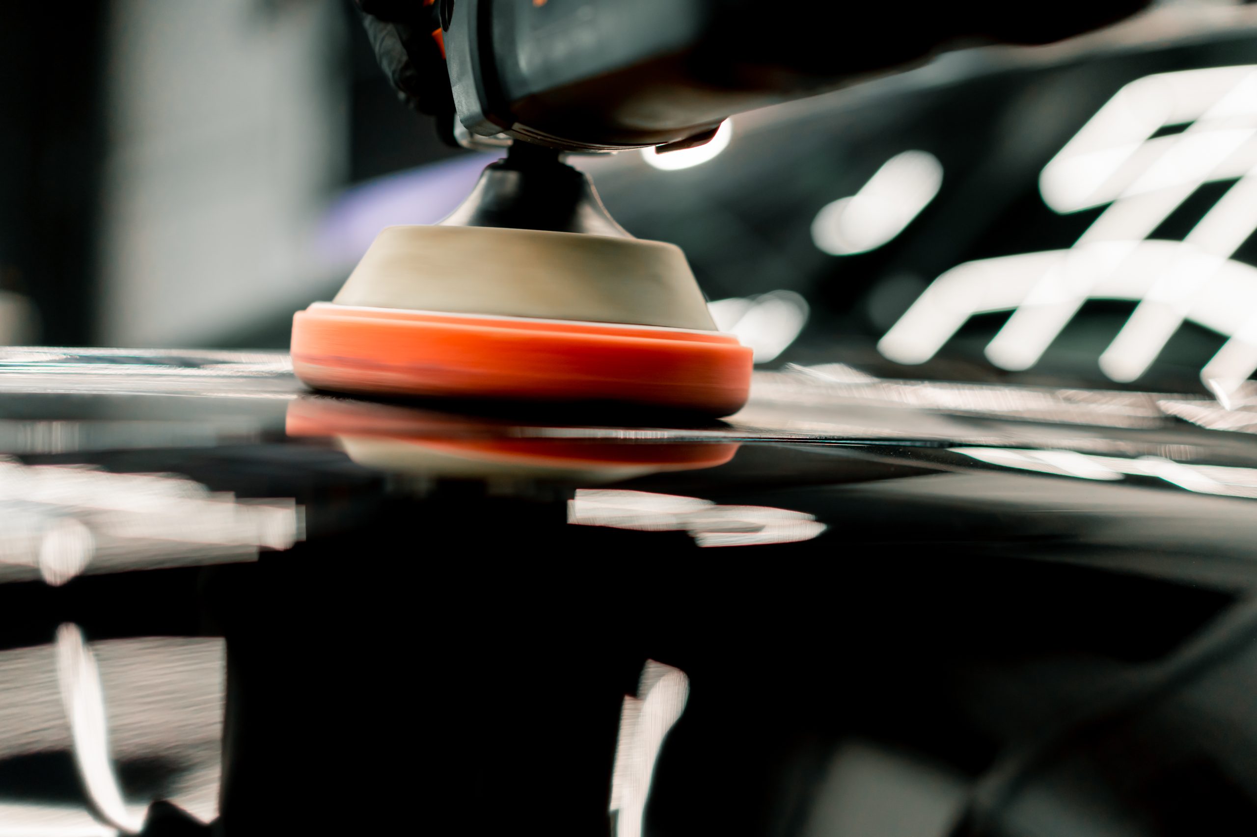Ceramic coating being polished onto a vehicle