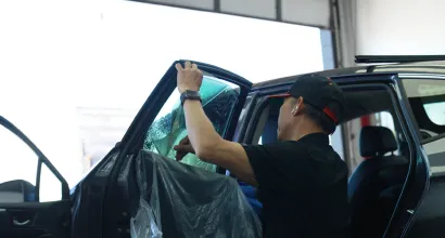 Window tint being installed at Mr. Tint PPF & Coatings
