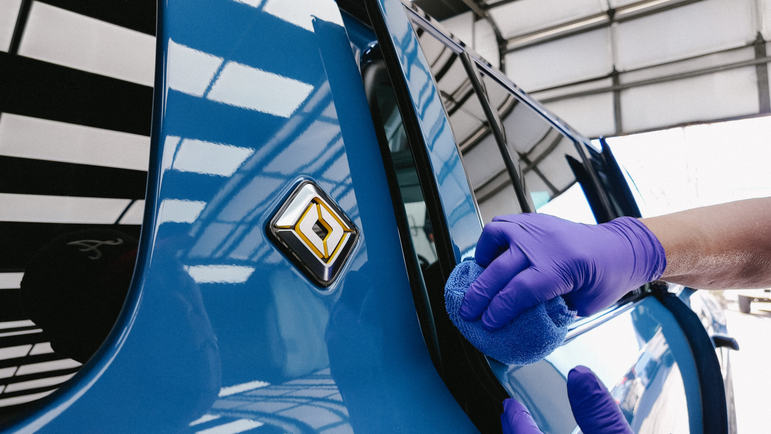 Ceramic coating product being applied to a vehicle at Mr. Tint PPF & Coatings